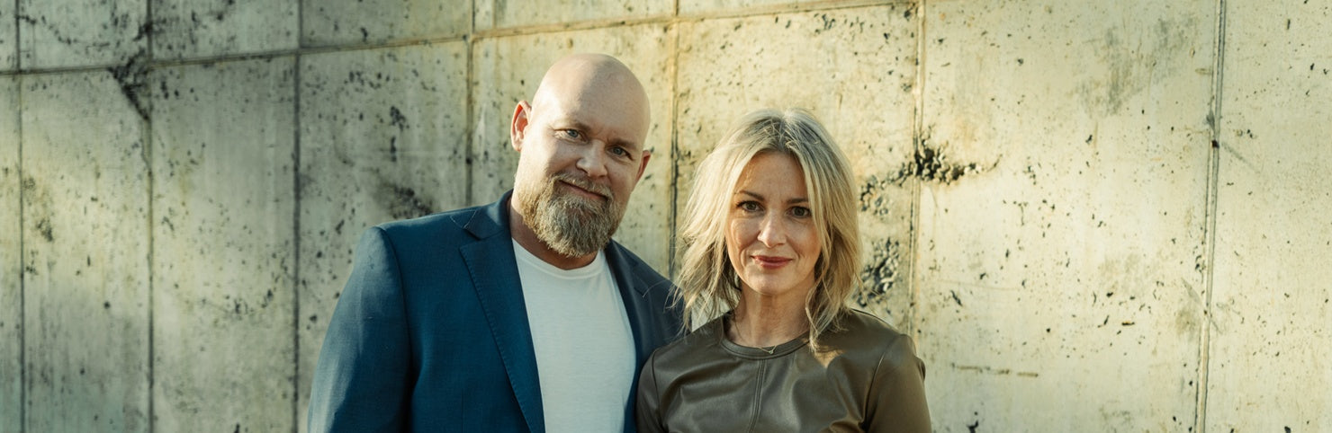 Jennifer Houde and Bob Houde, founders of Maison Avenir, standing together in their Greenville boutique showcasing curated luxury fashion.