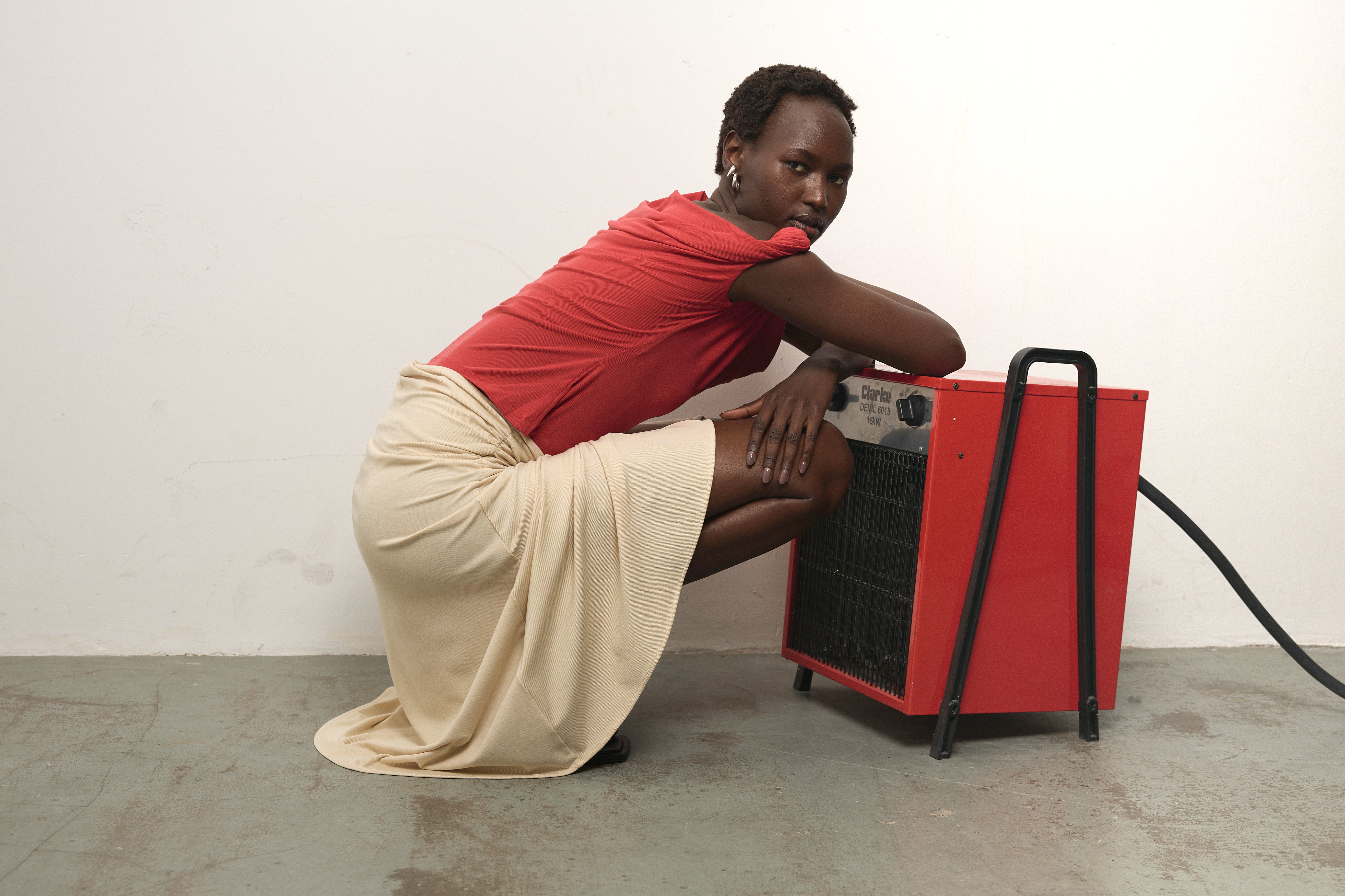 Model kneeling down wearing Paris Georgia Ida Top in red