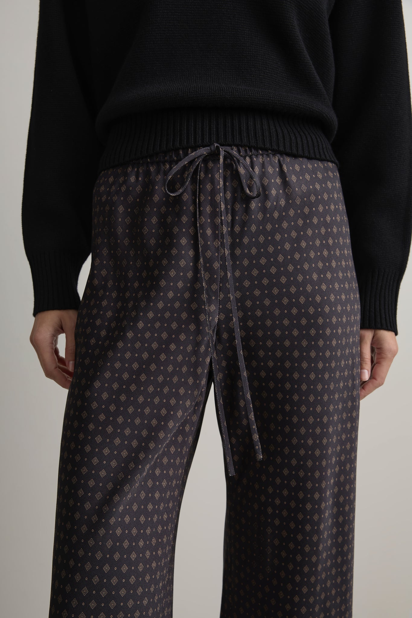 Close up of Woman wearing A Emery Estee Bias Pant in Ink Foulard against a neutral background