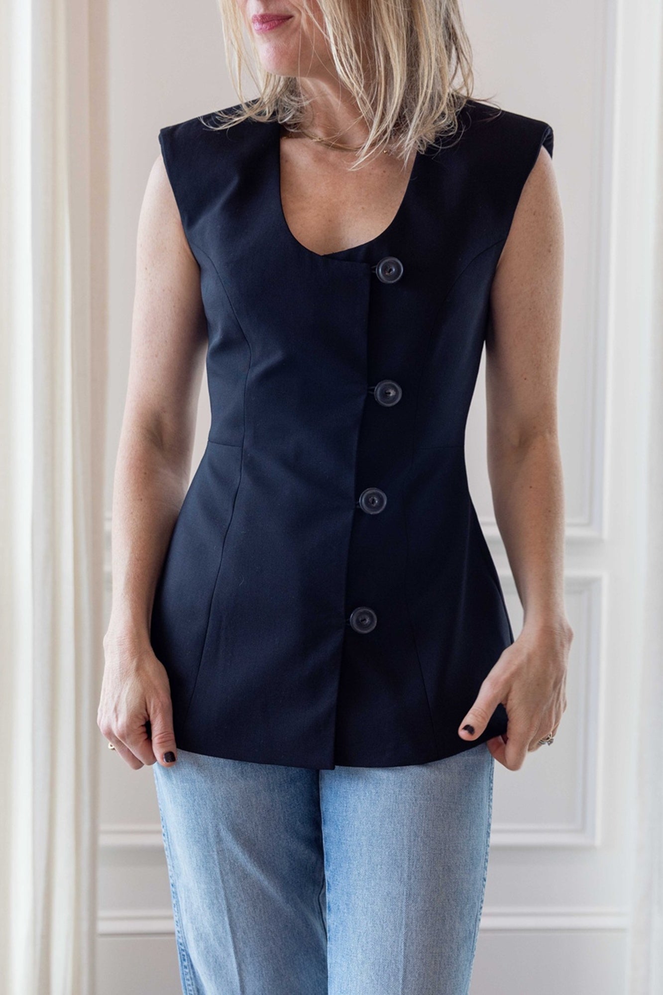 Woman wearing the house of dagmar sleeveless blazer.