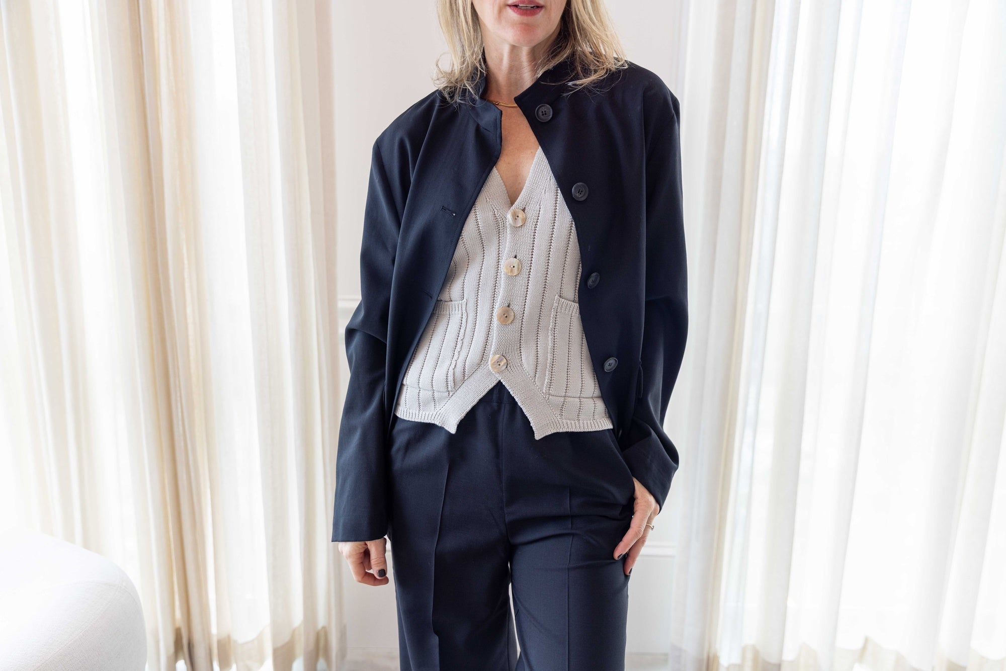 close up of a woman wearing the amo marlowe vest and house of dagmar wool overshirt