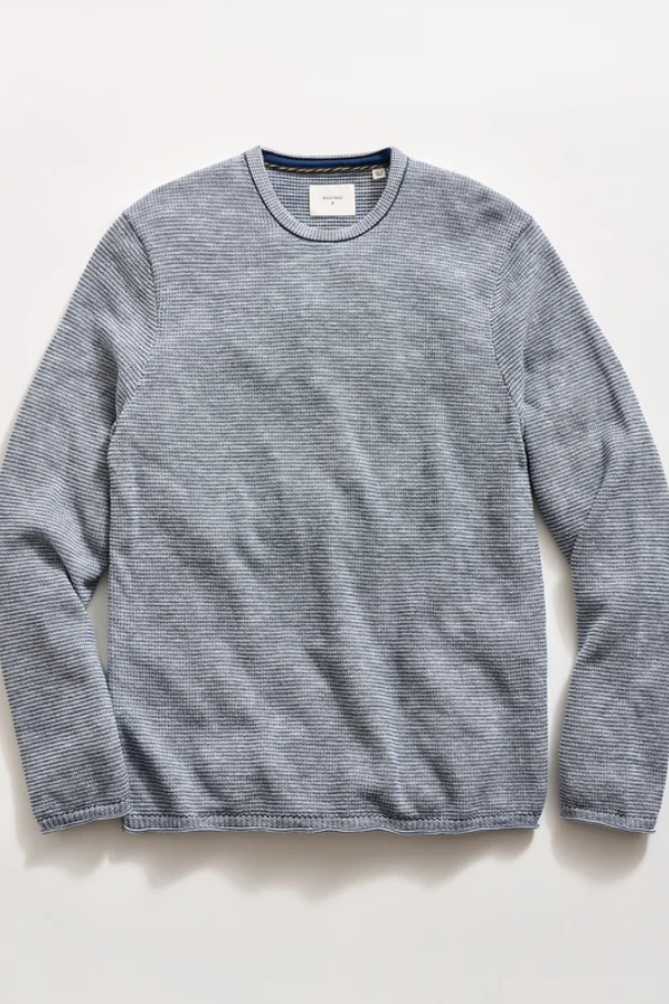 A heather gray long-sleeve crewneck knit sweater laid flat on a light off-white background.