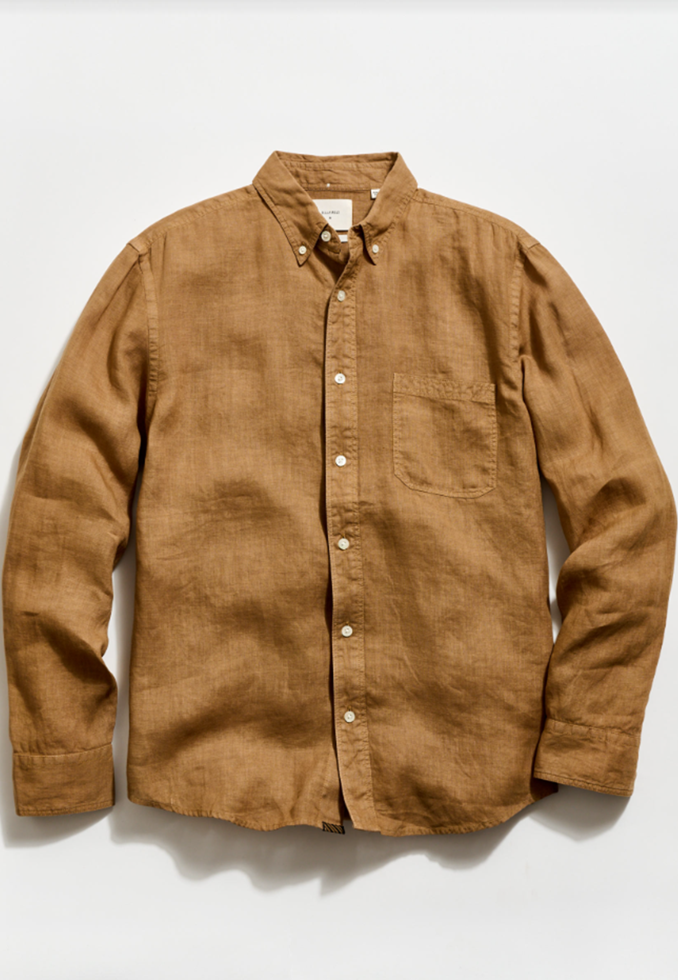 Brown button-up shirt on a white background