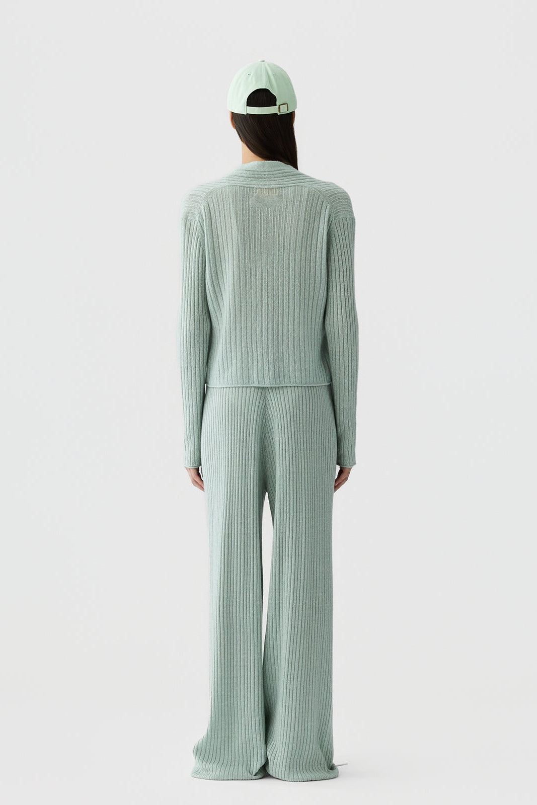 image of a model wearing the Guest in Residence Rib Stealth Cardigan in Sage Brush