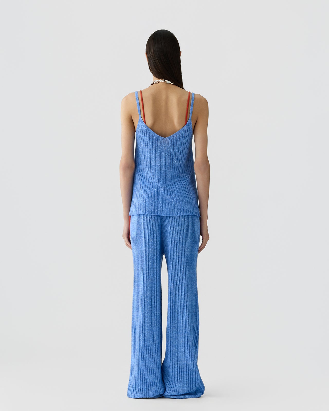Back image of a model wearing the Guest in Residence Breezy Rib Tank in Delft Blue