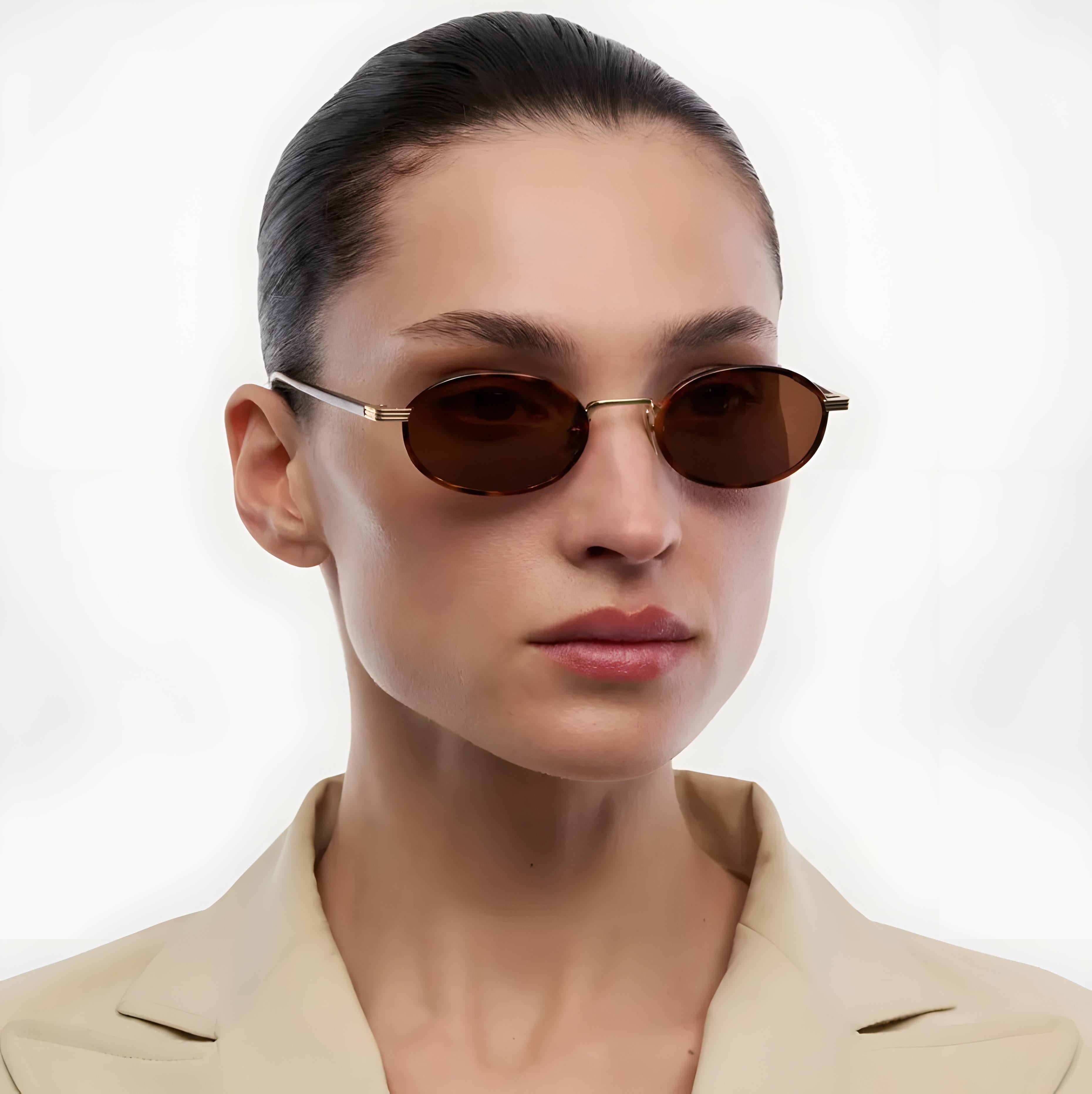 Woman wearing sunglasses with a plain background