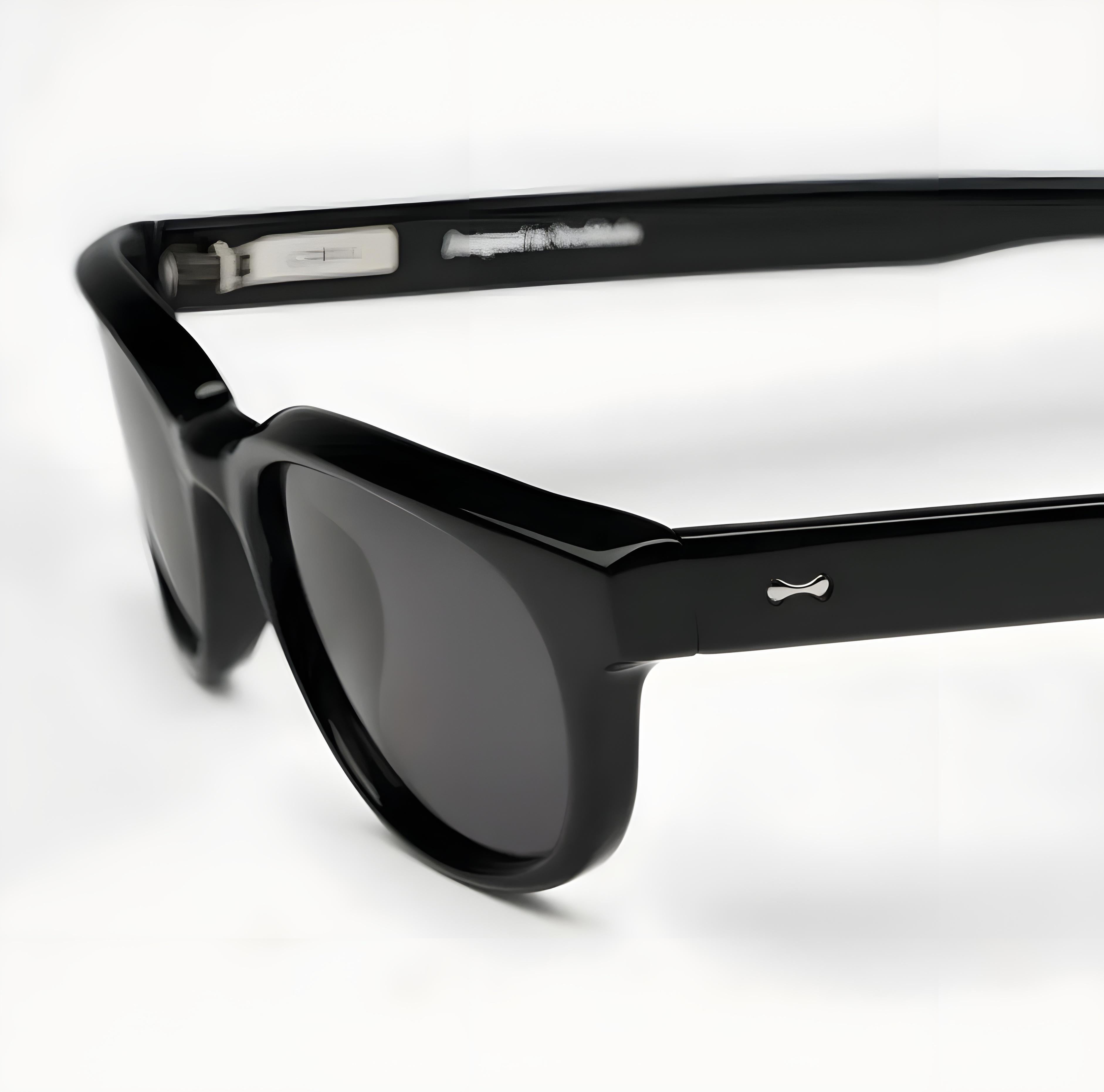 Black sunglasses with a brand logo on a white background