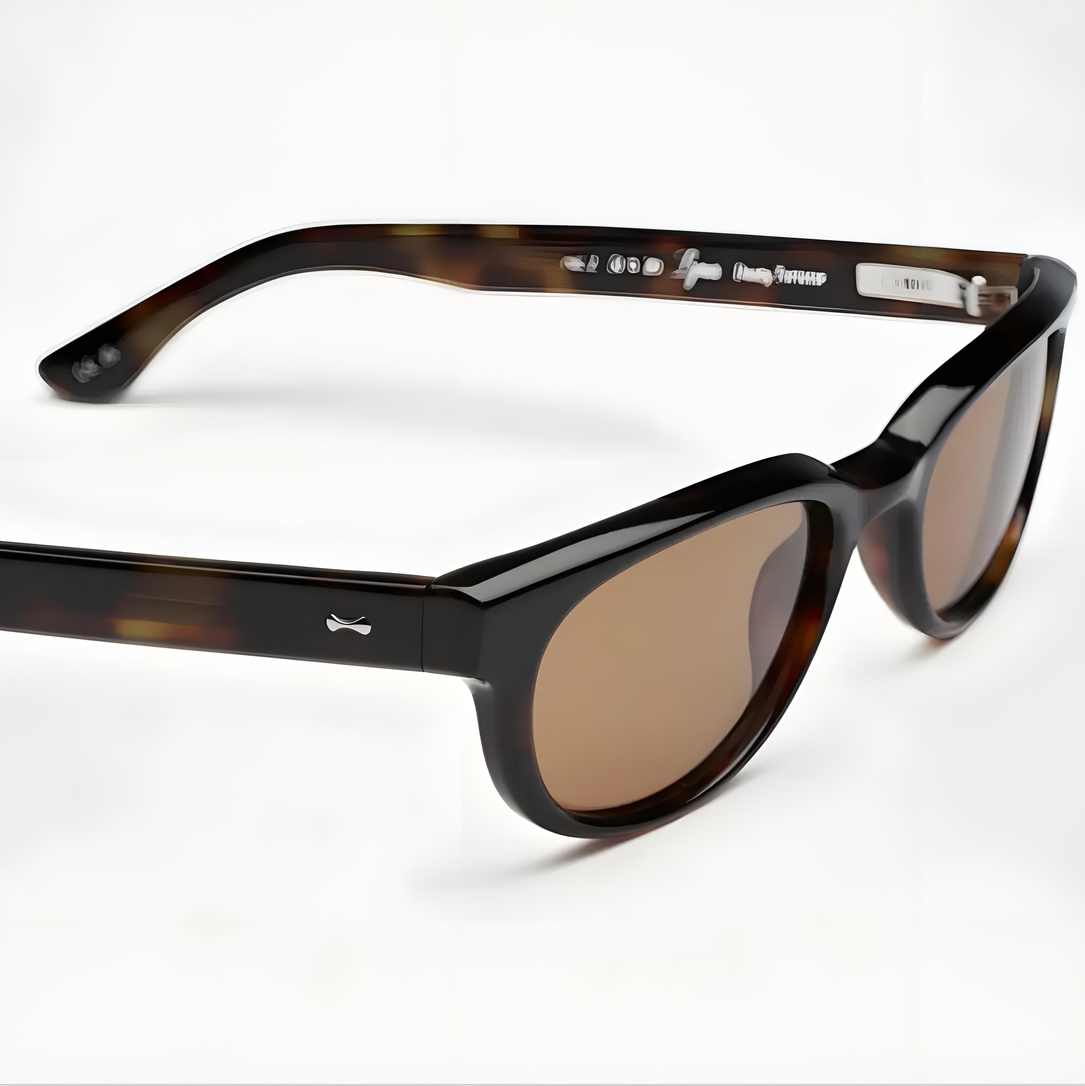 Sunglasses with tortoiseshell frame and brown lenses on a white background
