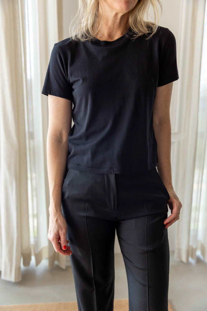 Eterne Short Sleeve Boxy Tee in black cotton modal, worn front view of the crew neckline with tailored trousers