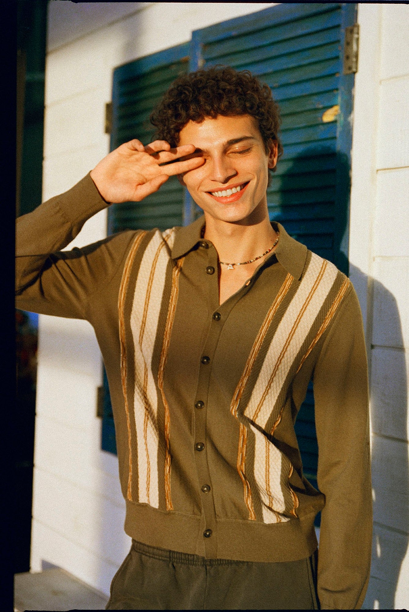 Man wearing a patterned shirt with a blurred background