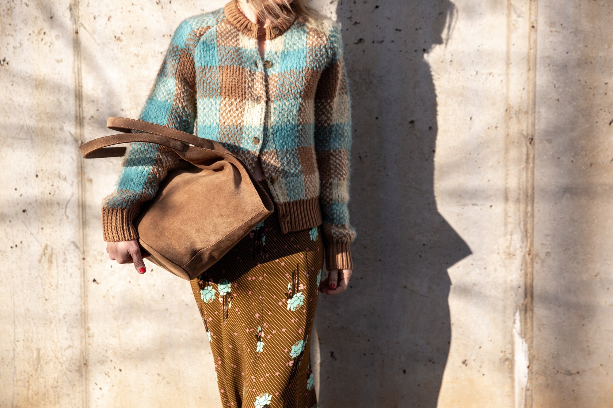 image of a woman wearing the Guest in Residence Buffalo Plaid Cardigan and Rachel Comey Blushing Skirt with an Aesther Ekme Handbag