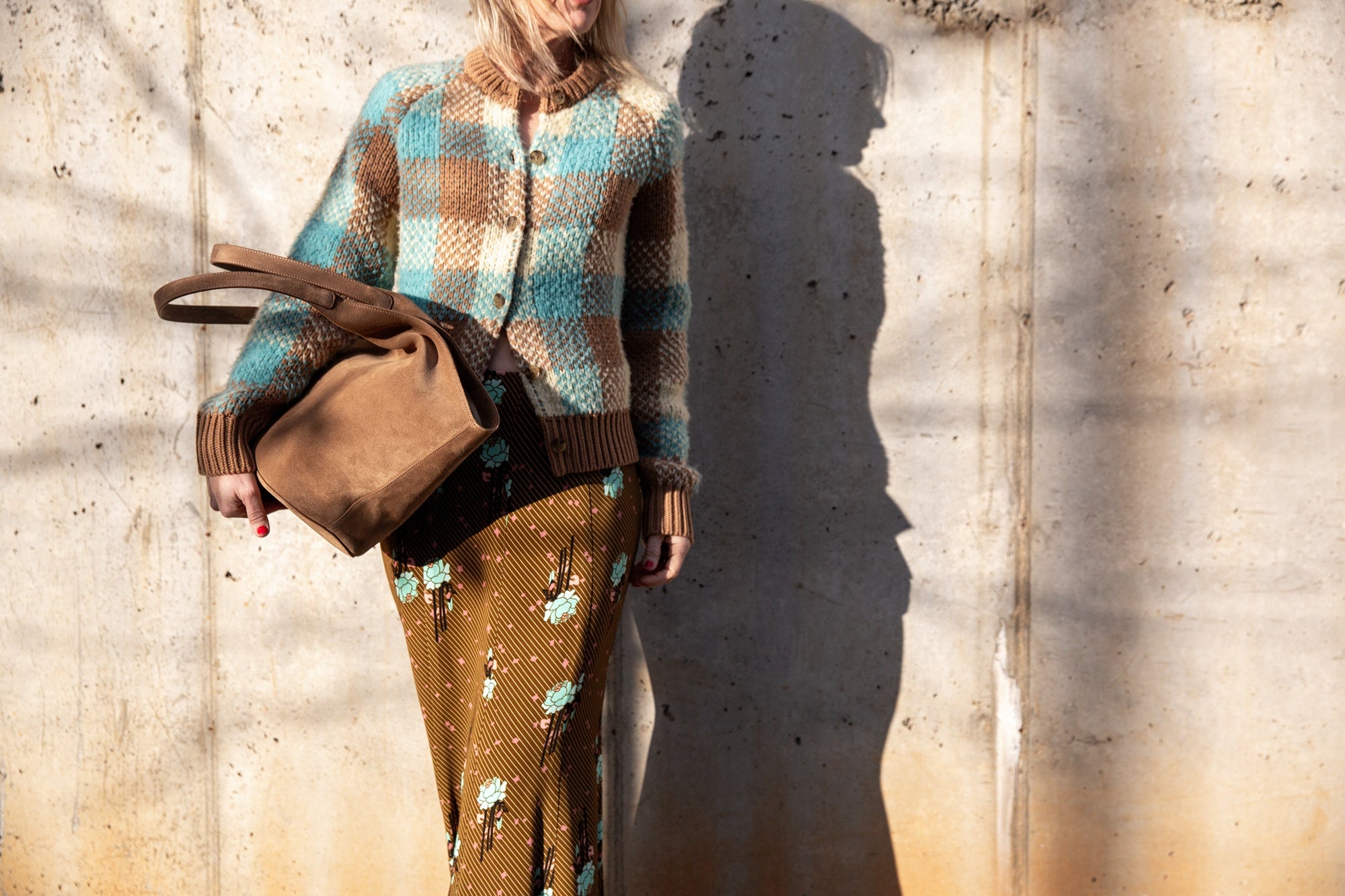 image of a woman wearing the Guest in Residence Buffalo Plaid Cardigan and Rachel Comey Blushing Skirt with an Aesther Ekme Handbag