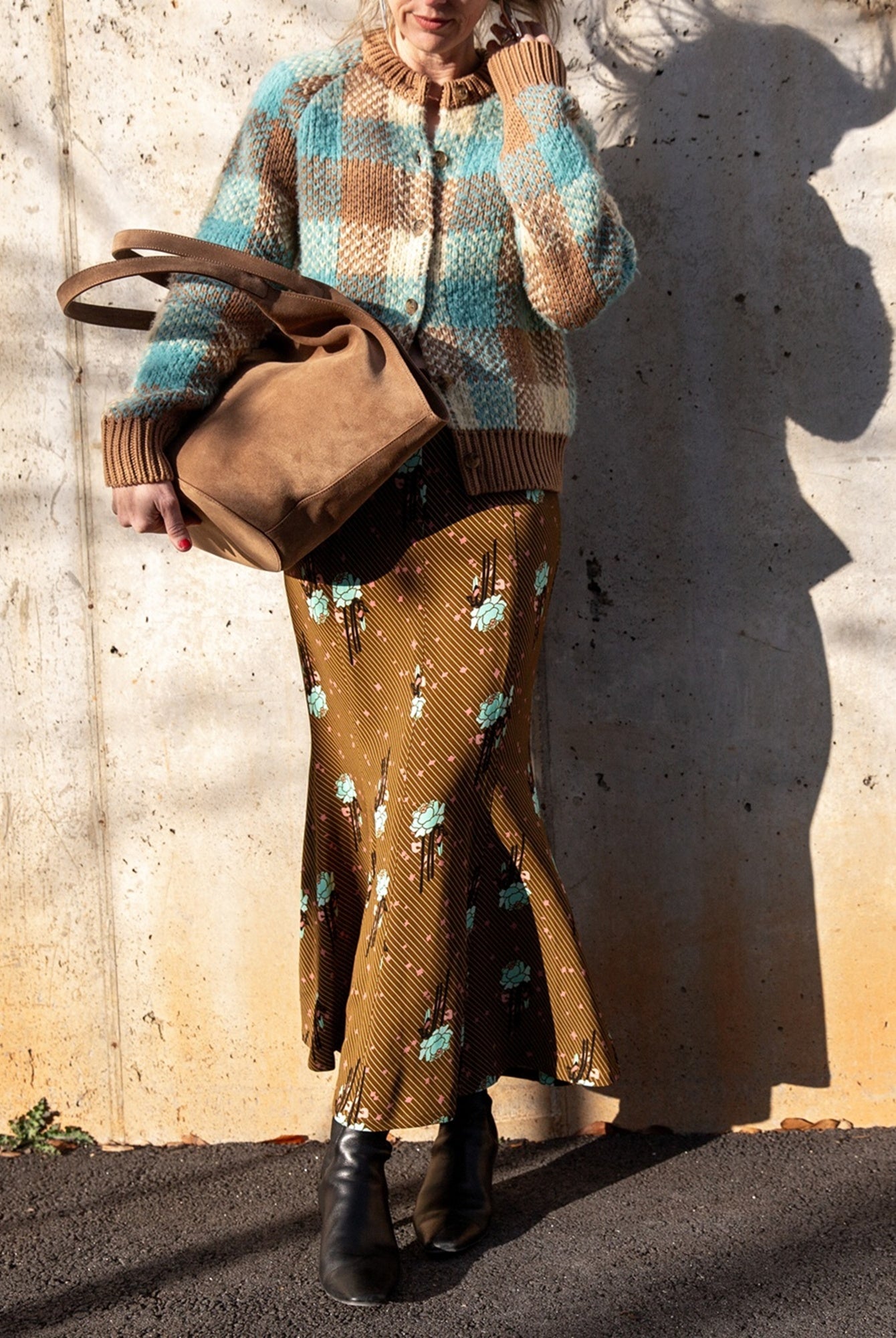 image of a woman wearing a Guest in Residence Cardigan, Rachel Comey Blushing Skirt with Aesther Ekme Handbag