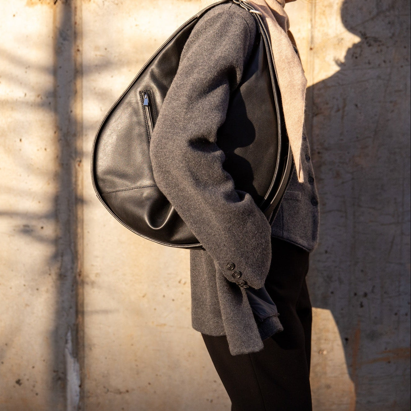 image of a woman wearing the Janessa Leone Handbag with the Guest in Residence Tailored Blazer