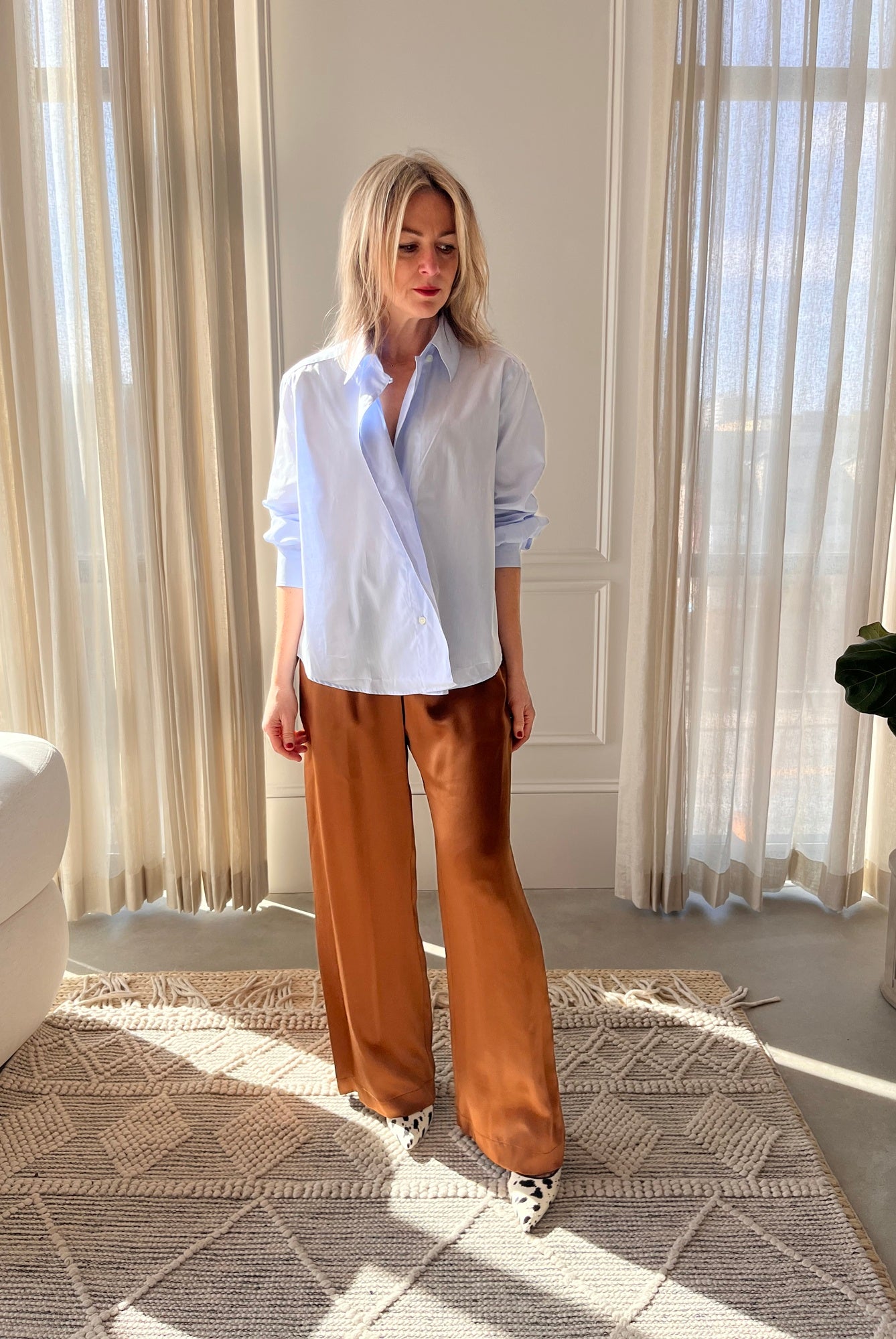 image of a woman wearing the House of Dagmar Cropped Shirt and Sablyn Brynn Pants with the Studio Amelia Alta Cow Mules