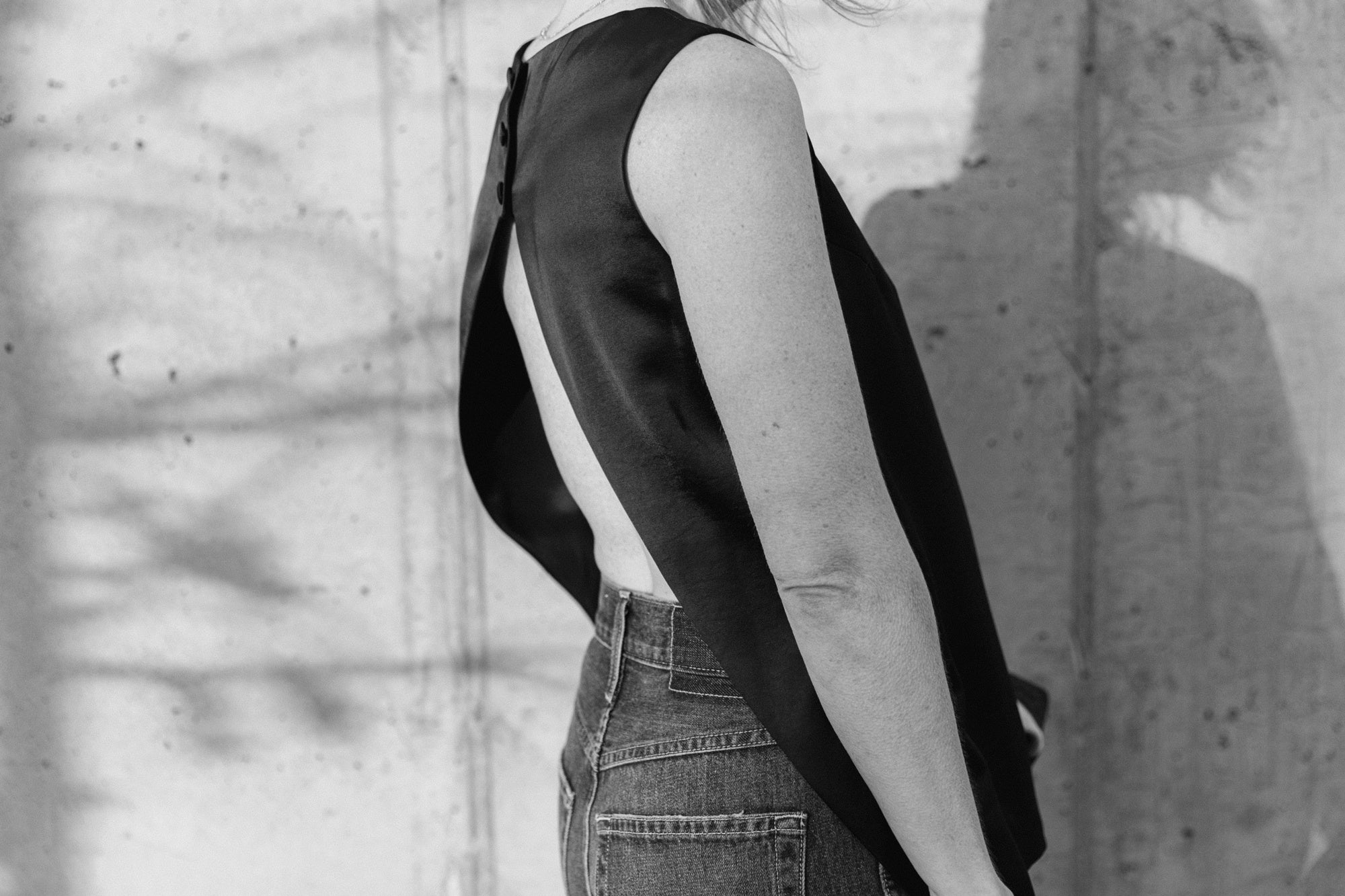 side view of the amo annette jeans in persuasion and the house of dagmar open back satin top