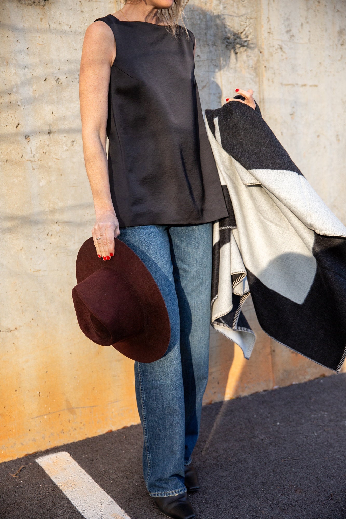 image of a woman wearing a house of dagmar open back satin top and the amo annette jeans in persuasion