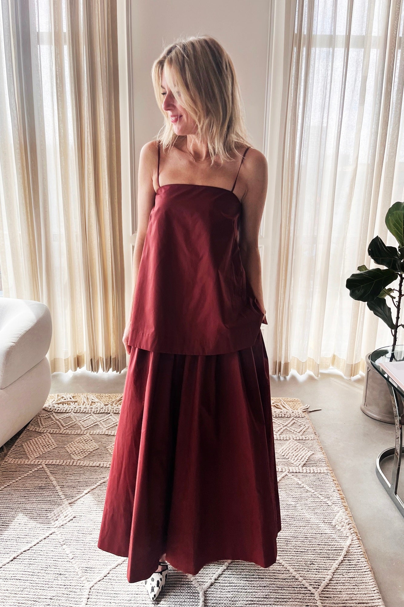 image of a woman wearing the house of dagmar cotton midi dress in mahogany