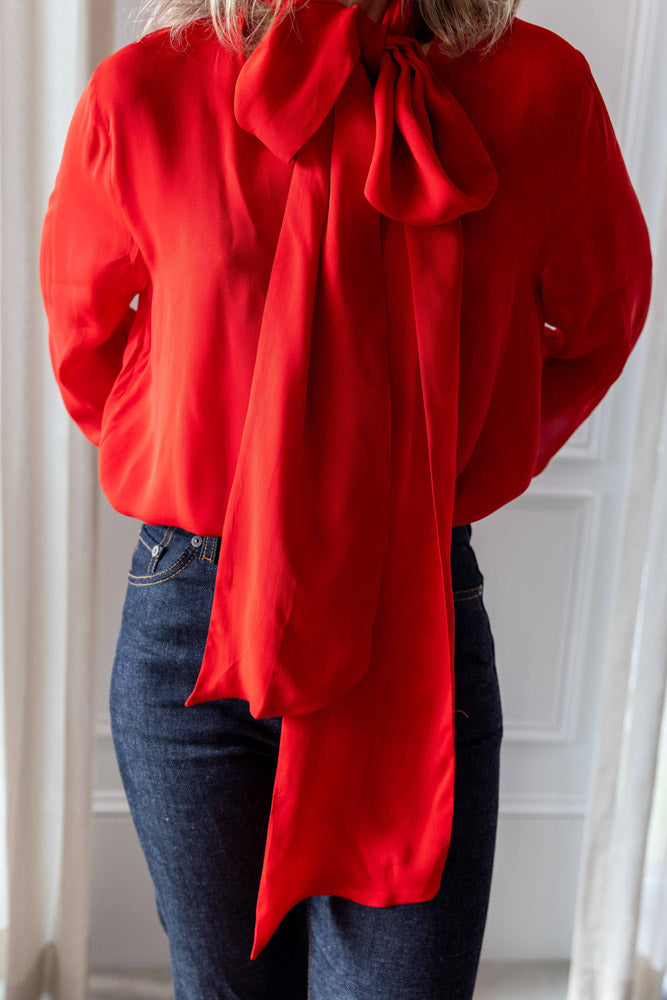 Dagmar Chiffon Scarf Blouse in red viscose, close front view of the draped scarf collar and fluid sleeves