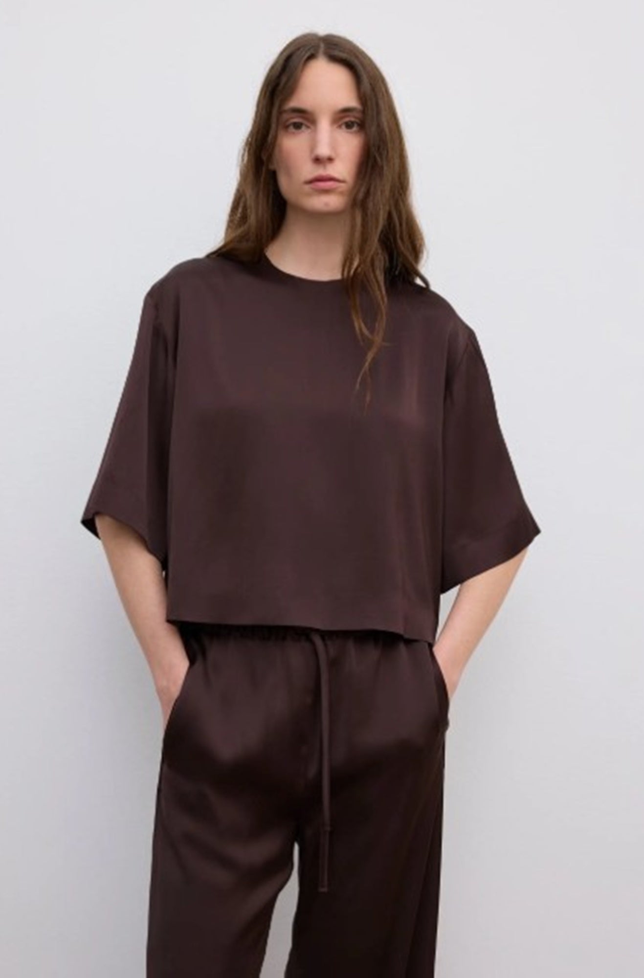 woman wearing the house of dagmar woven fluid shirt and drawstring trousers