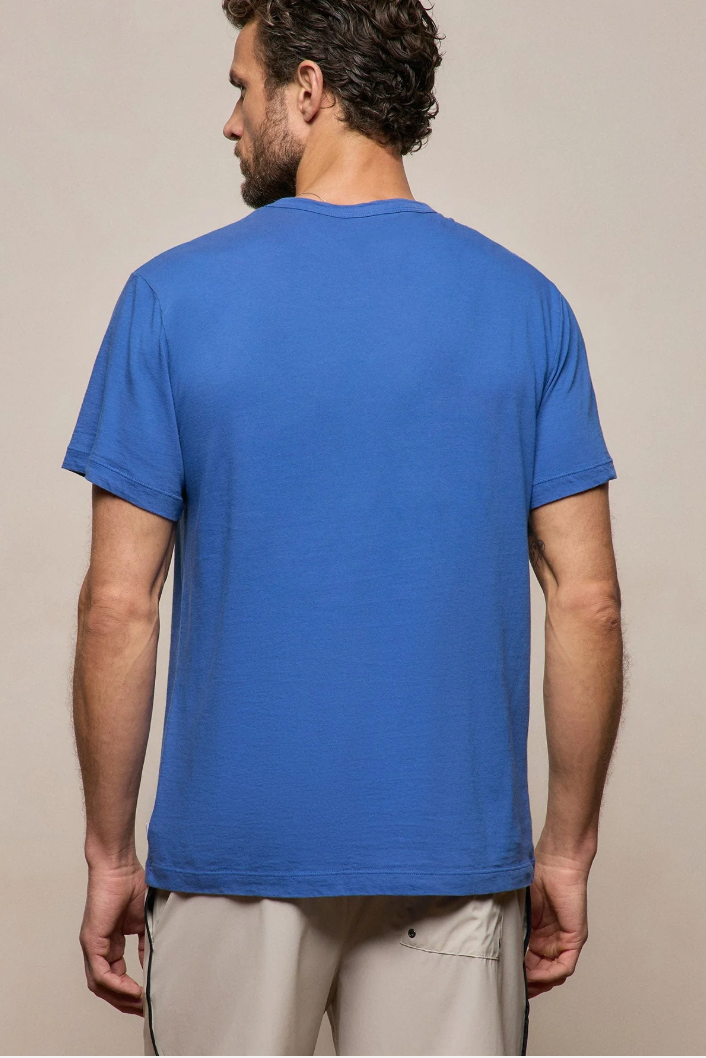 Man wearing a blue t-shirt against a beige background