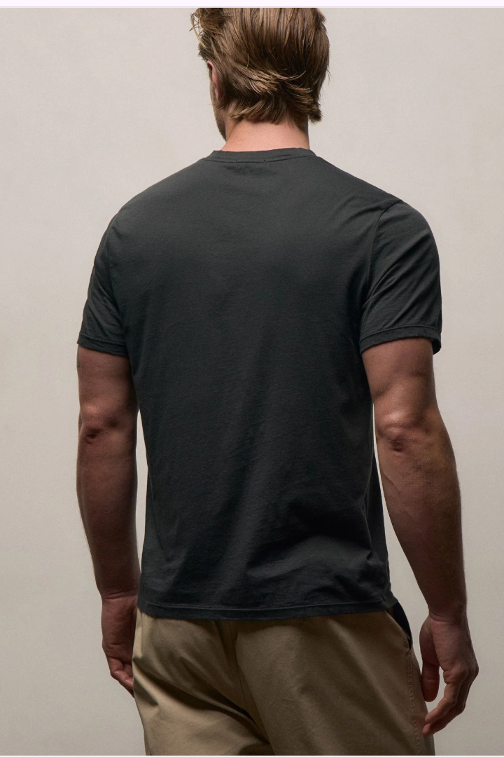 Man wearing a black t-shirt against a plain background
