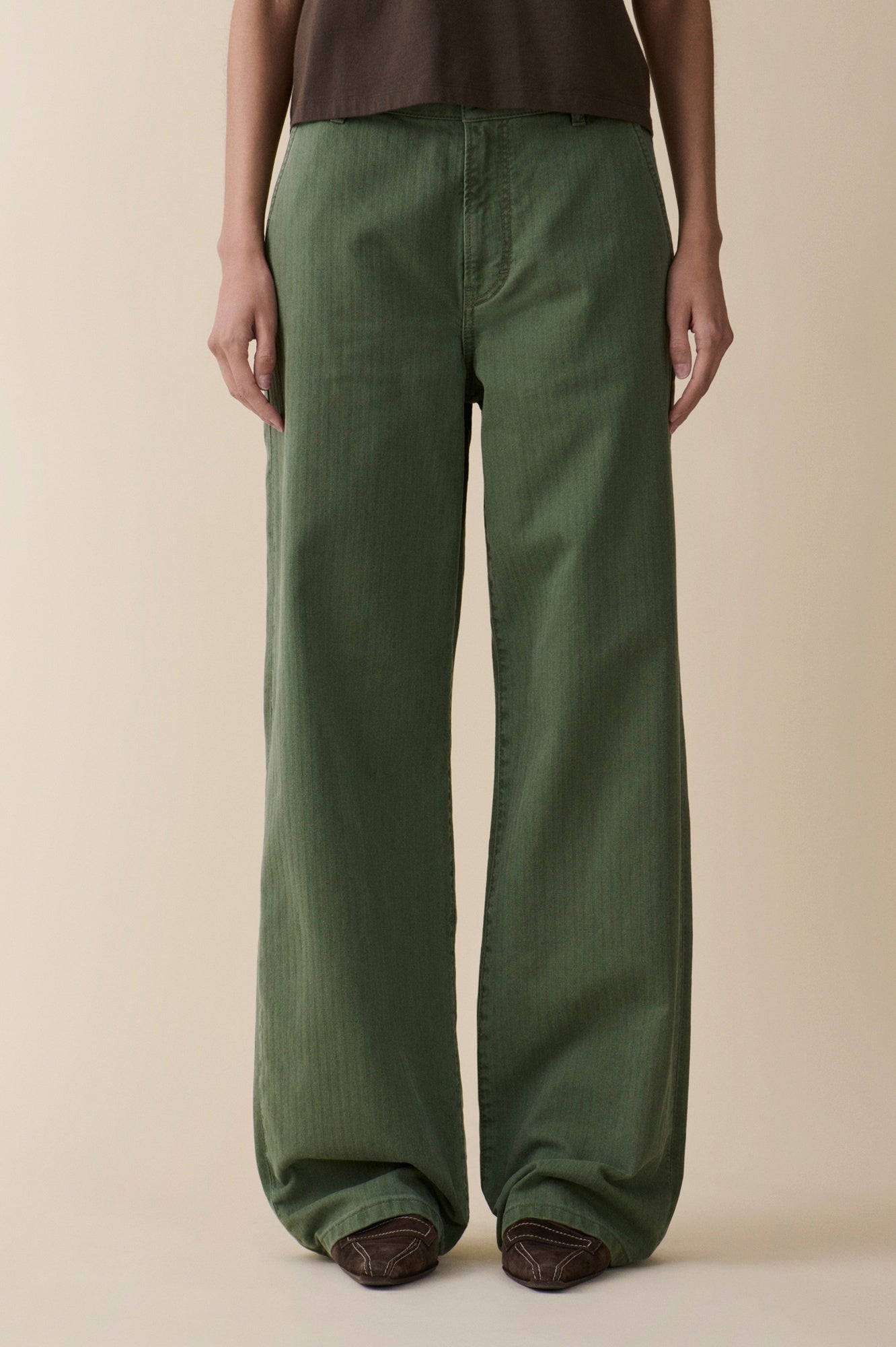 image of a model wearing the Jeanerica Belem Chinos in Green Herringbone