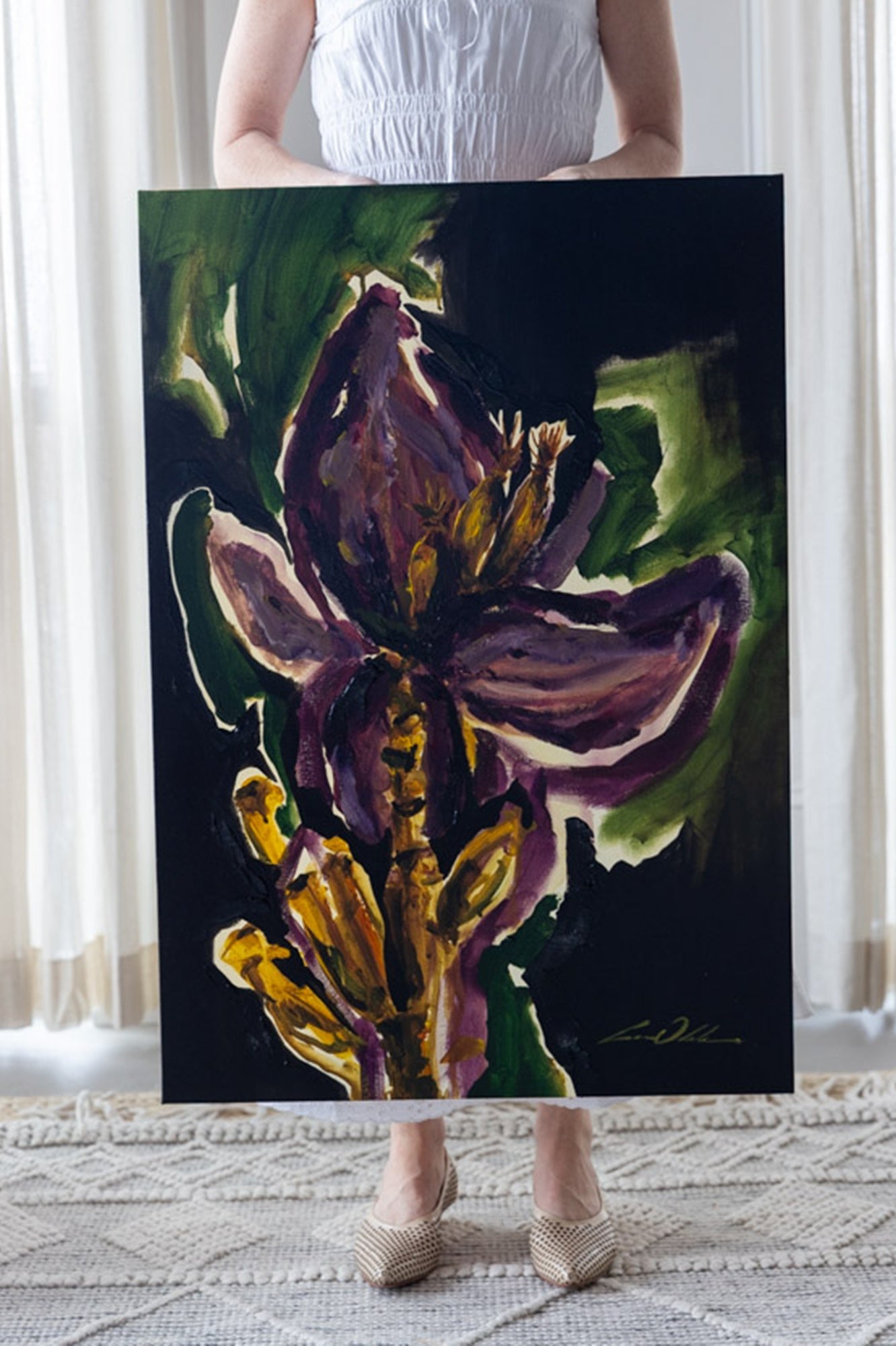 Person holding a large painting of a floral design