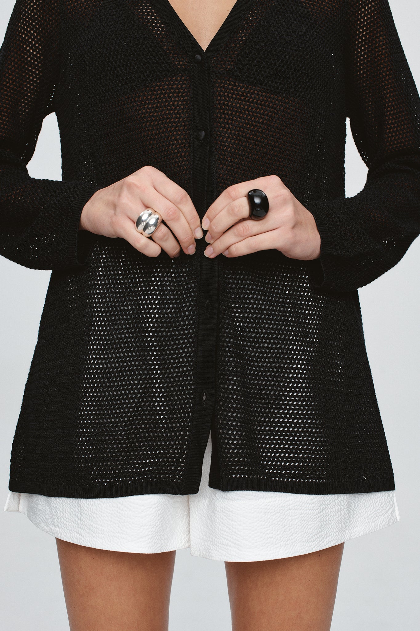 close up image of a model wearing the Marle Calla Cardigan in Black