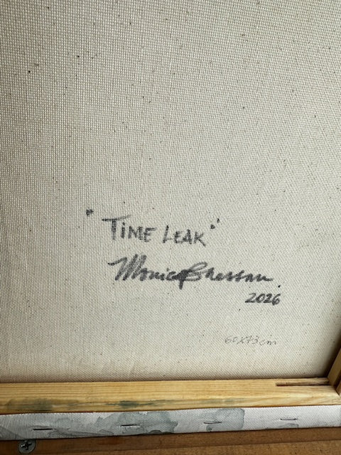 Signature on a textured surface with a wooden frame