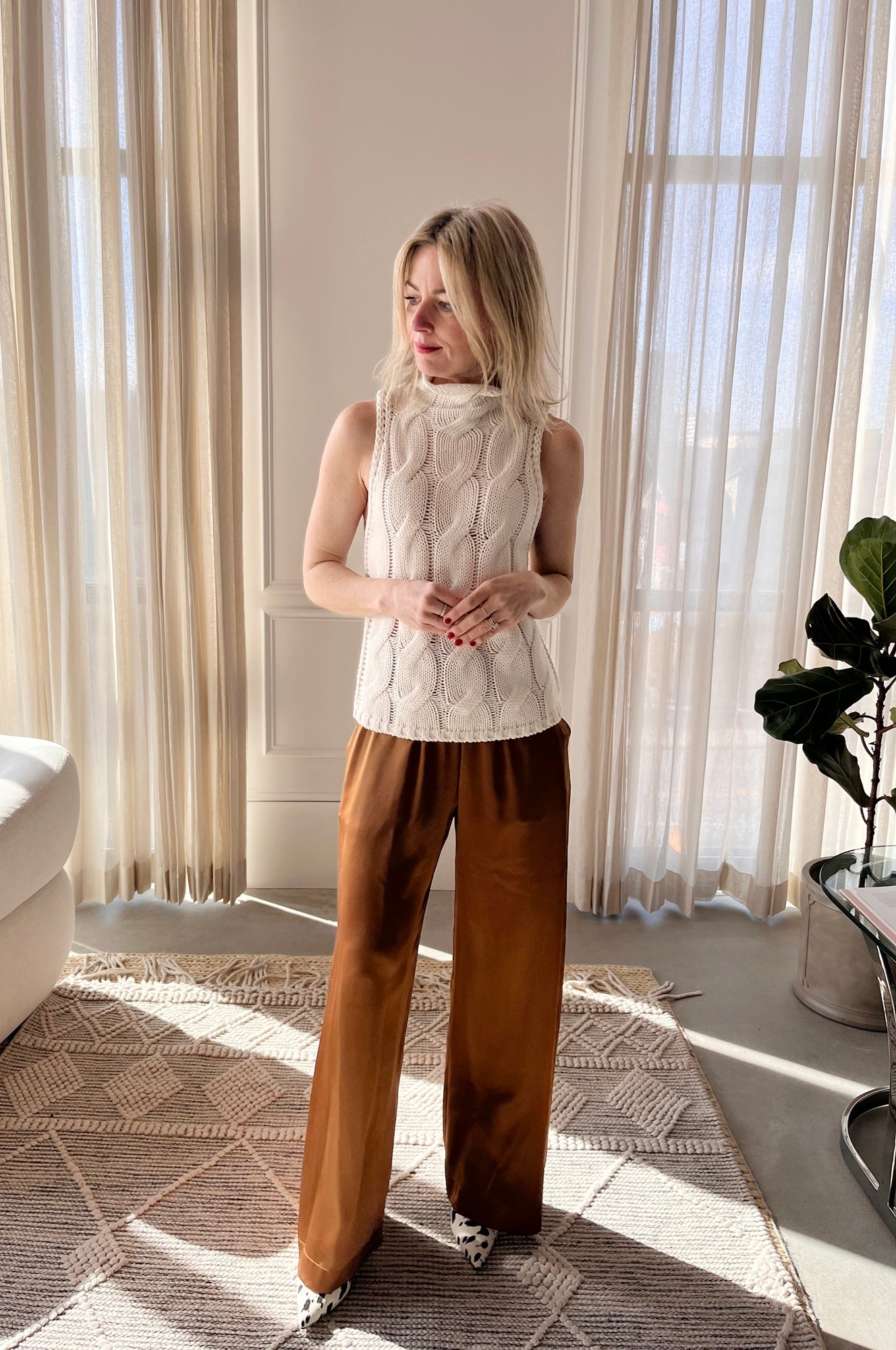 image of a woman wearing the Sablyn Salvia Sweater and Brynn Silk Pants