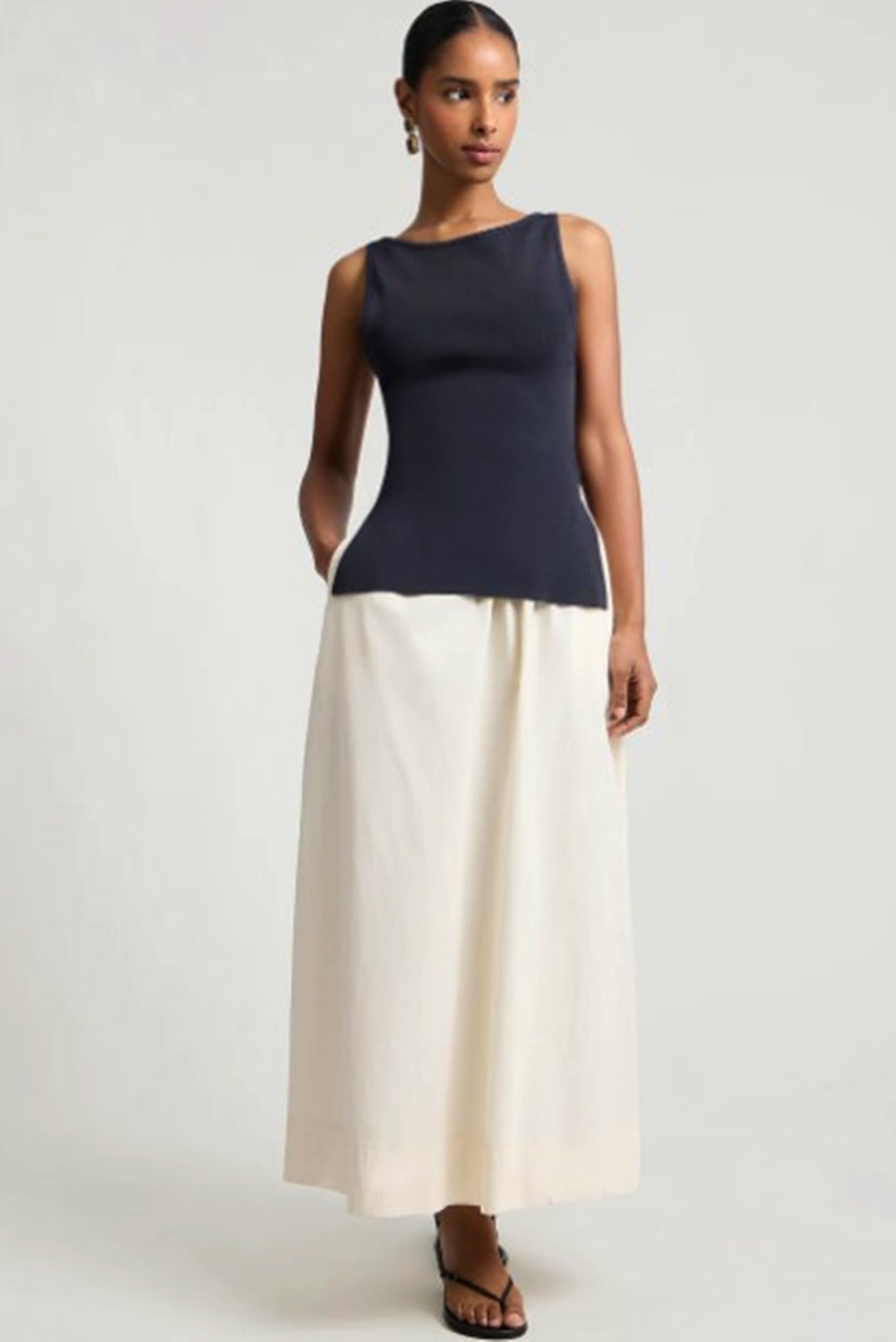 Woman wearing the onia boatneck mix media dress in front of a white background.
