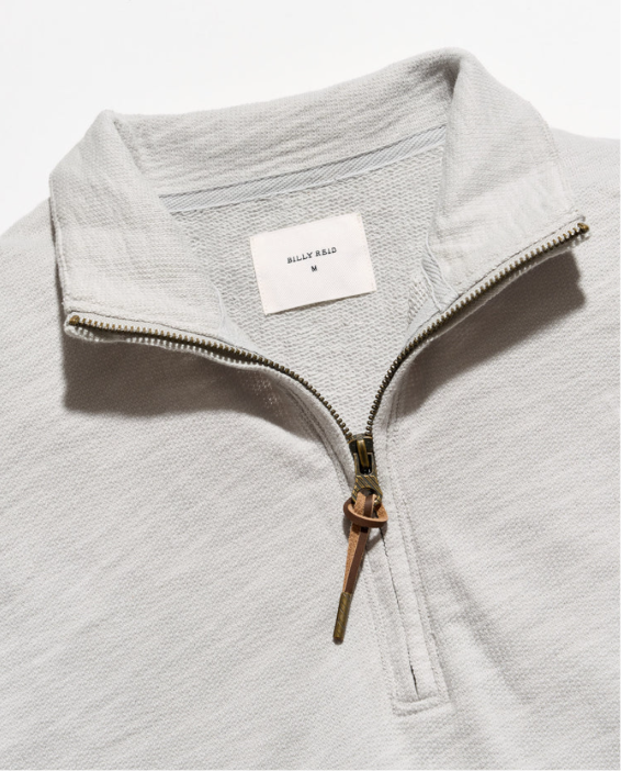 Close up of neck detailing of Billy Reid French Terry Half Zip against a white background
