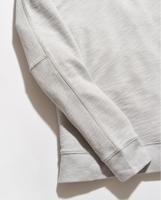 Close up of sleeve detailing on the Billy Reid French Terry Half Zip against a white background