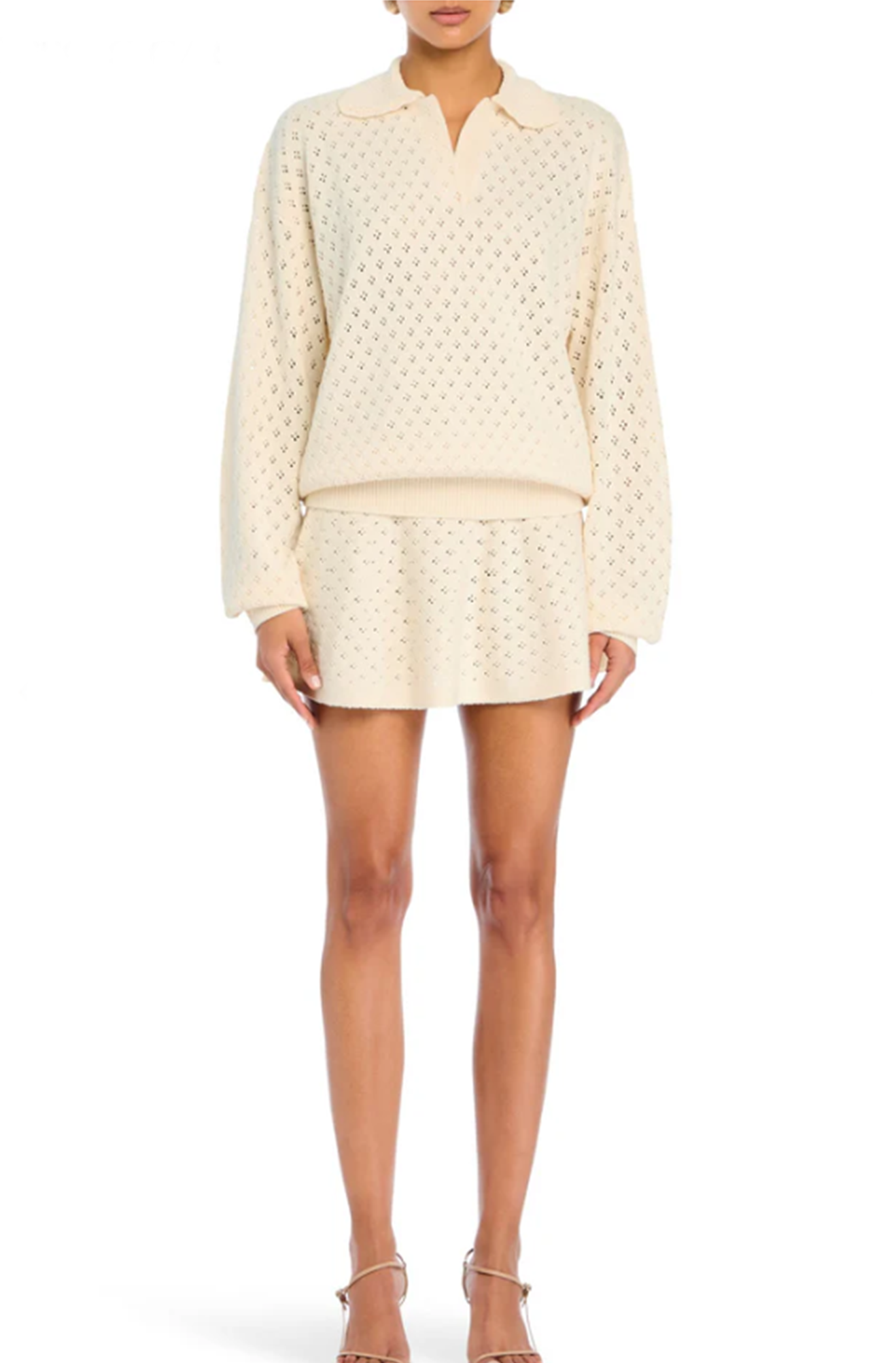 Person wearing a cream-colored textured outfit on a white background