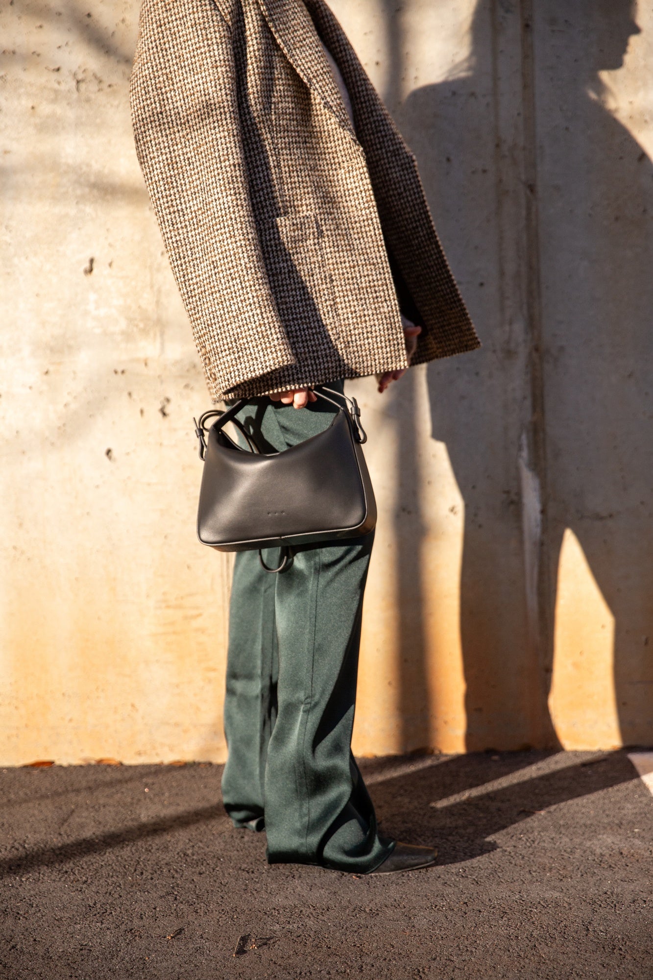 image of a woman wearing the House of Dagmar Tweed Blazer, Seroya Viva Satin Pants and Aesther Ekme Handbag