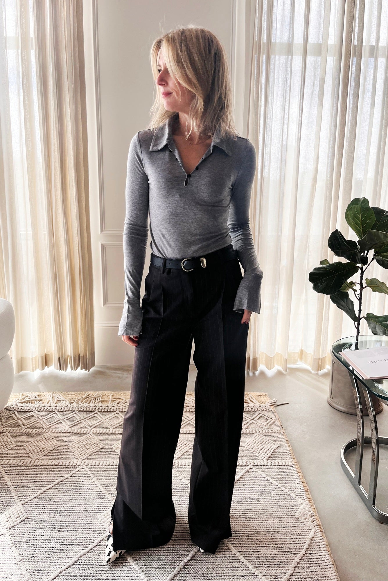 image of a woman wearing the Garment Bree Polo Top and Andora Pants with the Janessa Leone Myra Belt