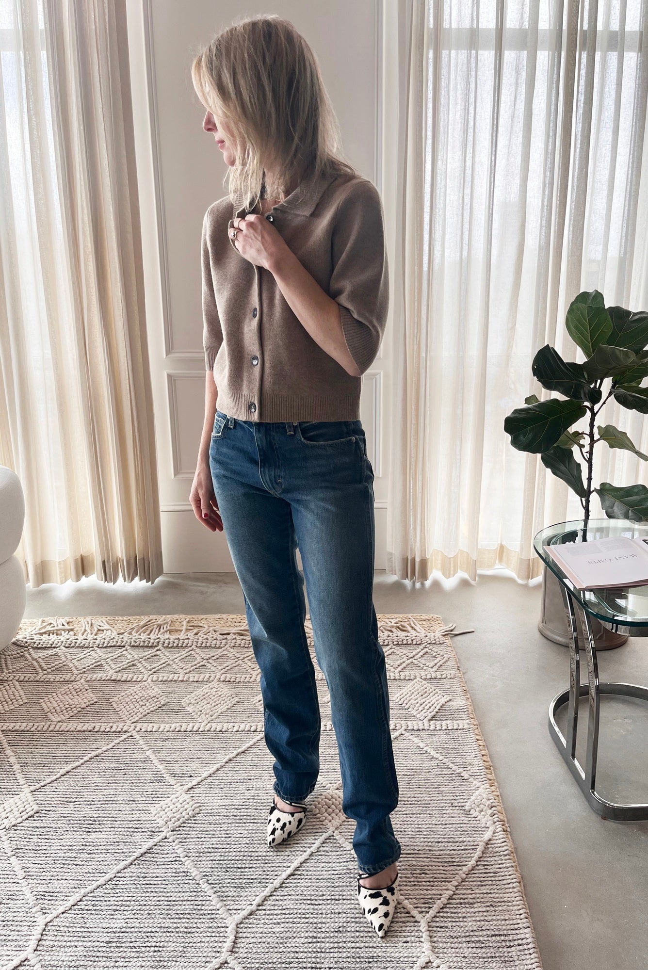 image of a woman wearing the Garment Como Cropped Cardigan, Amo Mira Jeans and Studio Amelia Alto Cow Mules