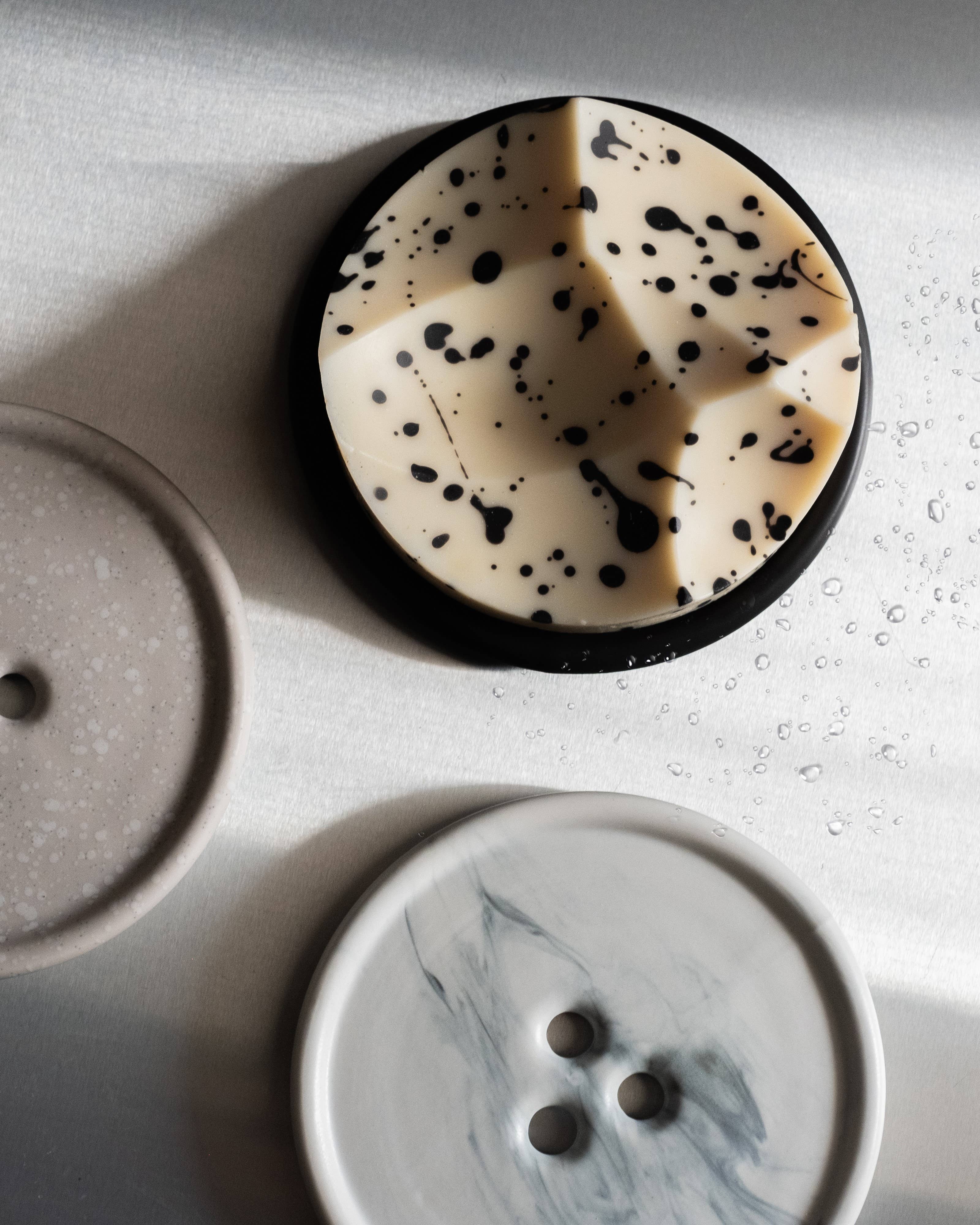 Soap with black speckles on a white surface
