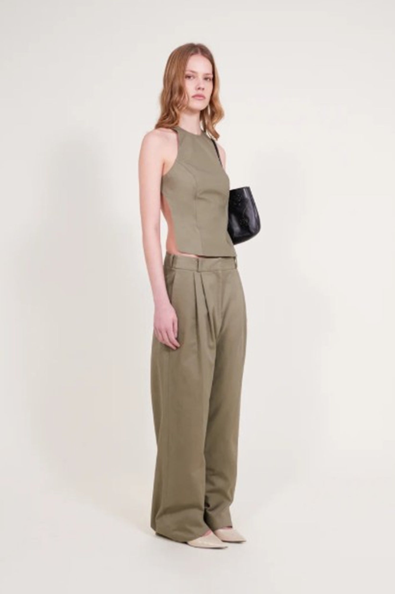 image of a model wearing the Alfie Backless top in khaki