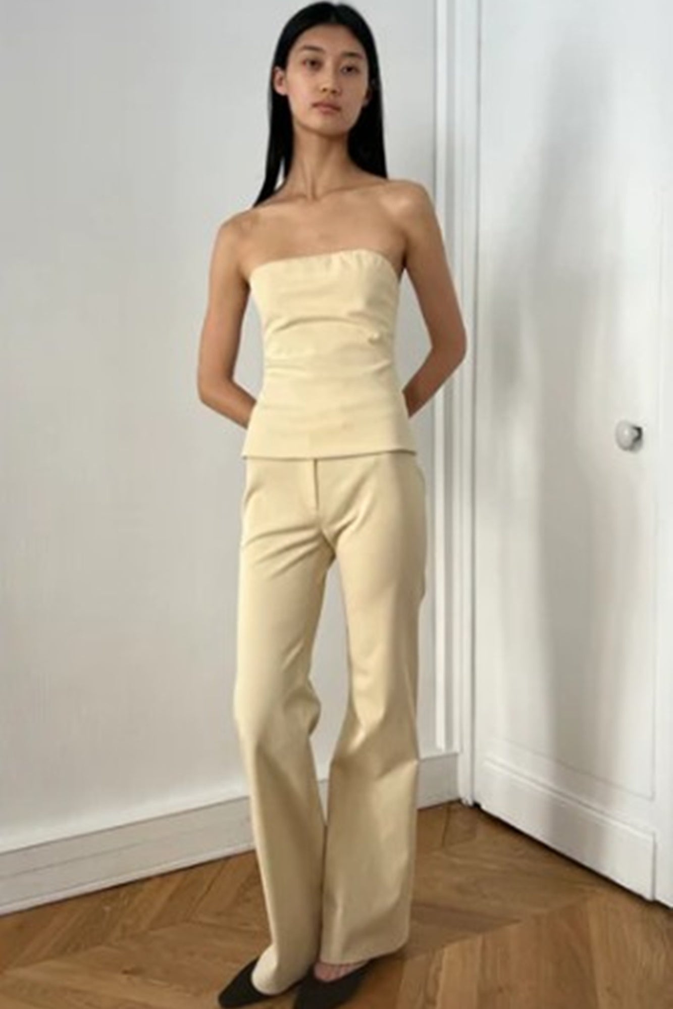 image of a model wearing the Alfie Bustier Top in sand and the Bell Pant in Sand