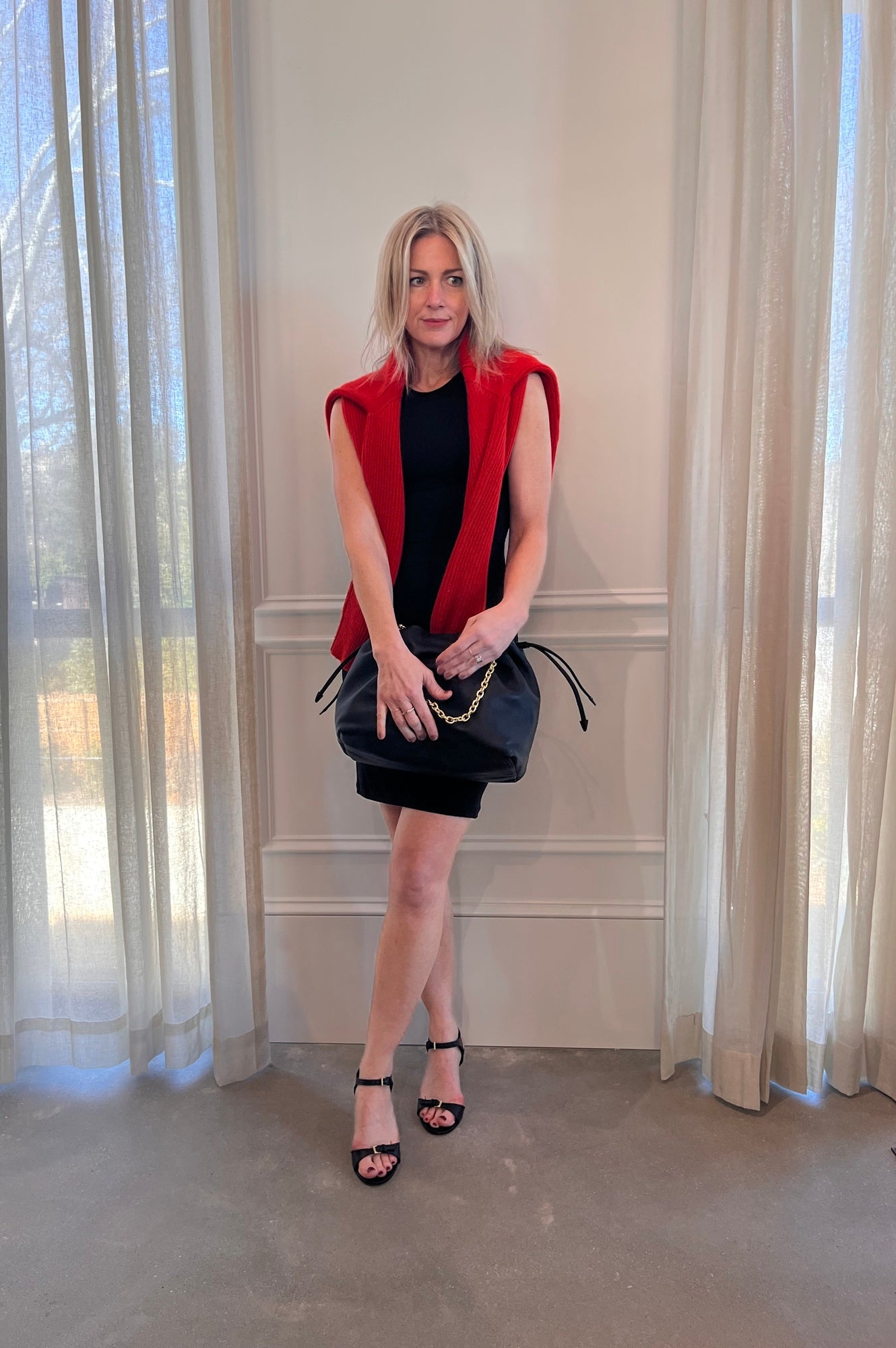 image of a woman wearing the Alfie Carrie Mini Dress and Studio Amelia Alexandra Handbag