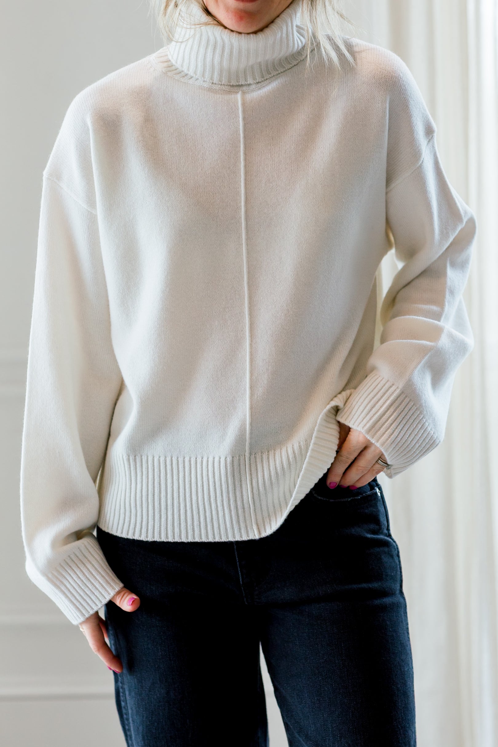 image of a woman wearing the allude turtleneck sweater
