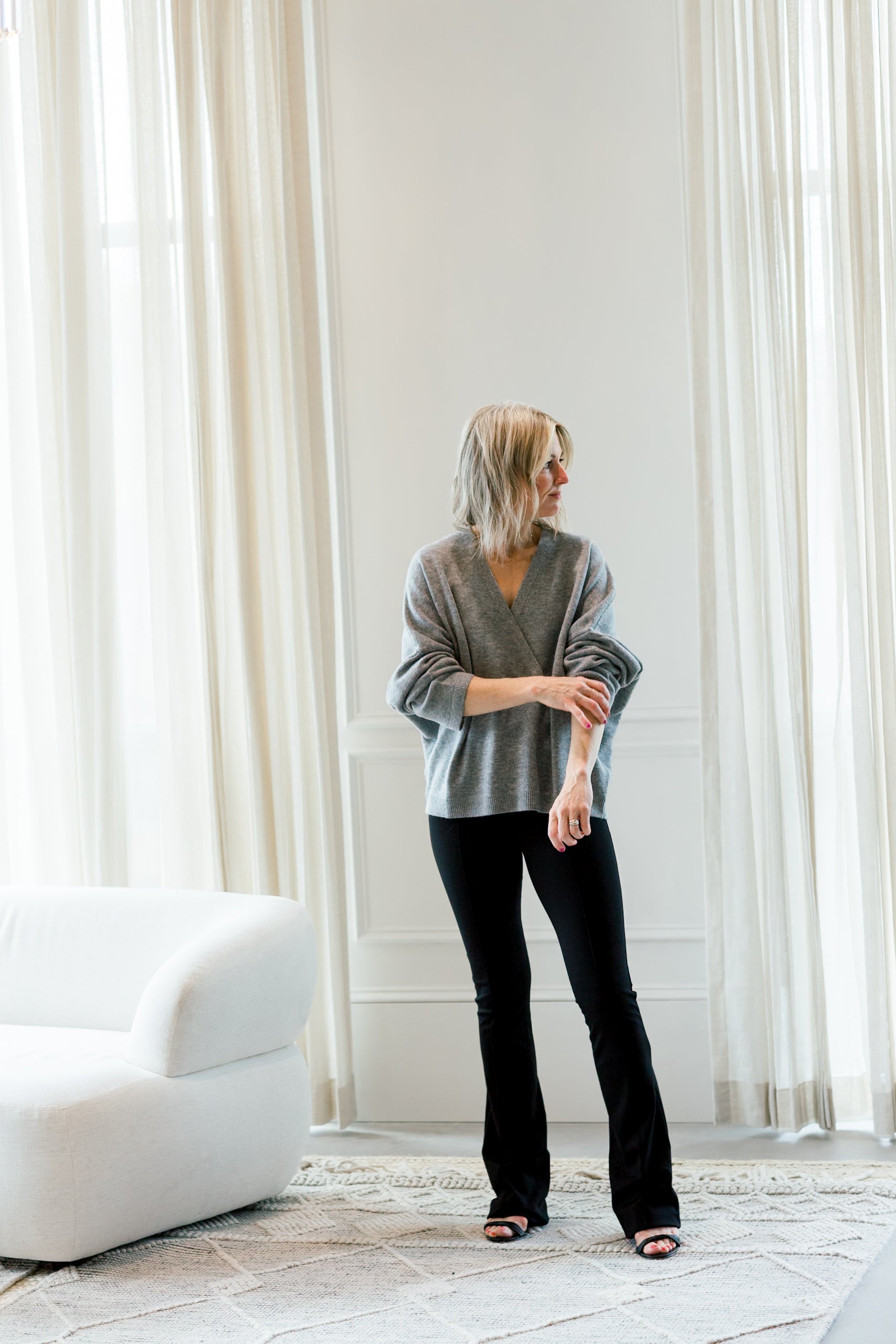 image of a woman wearing the allude v neck sweater and the garment chloe pants