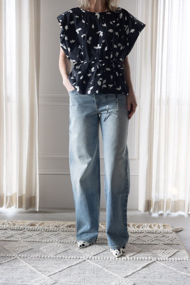 image of a woman wearing the Alysi Cotton Tie Waist Top and Sablyn Sammy Jeans