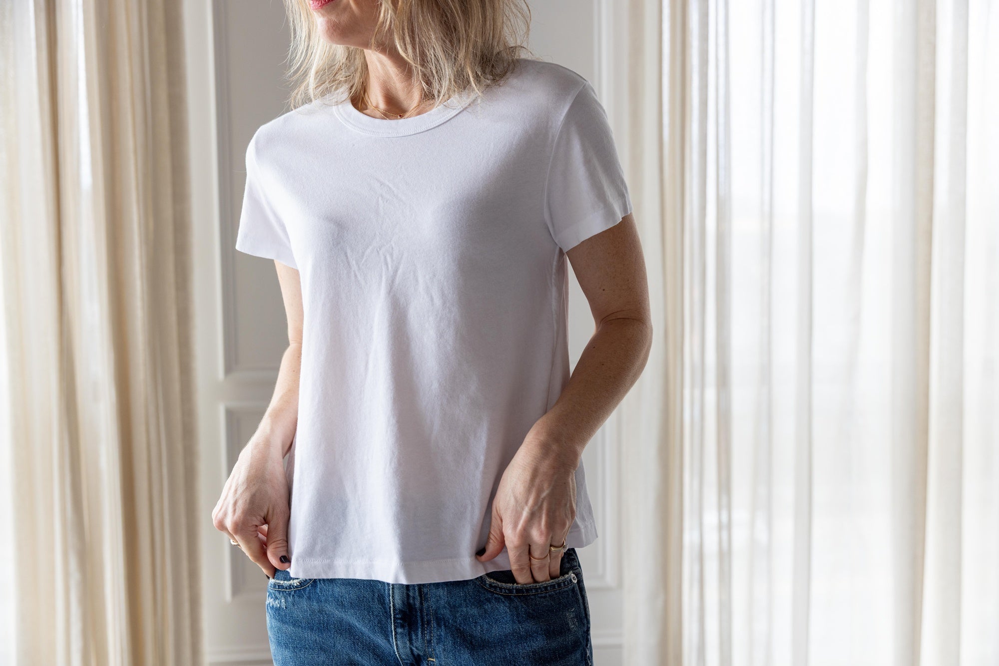 image of a woman wearing the Amo Lovey Tee in White