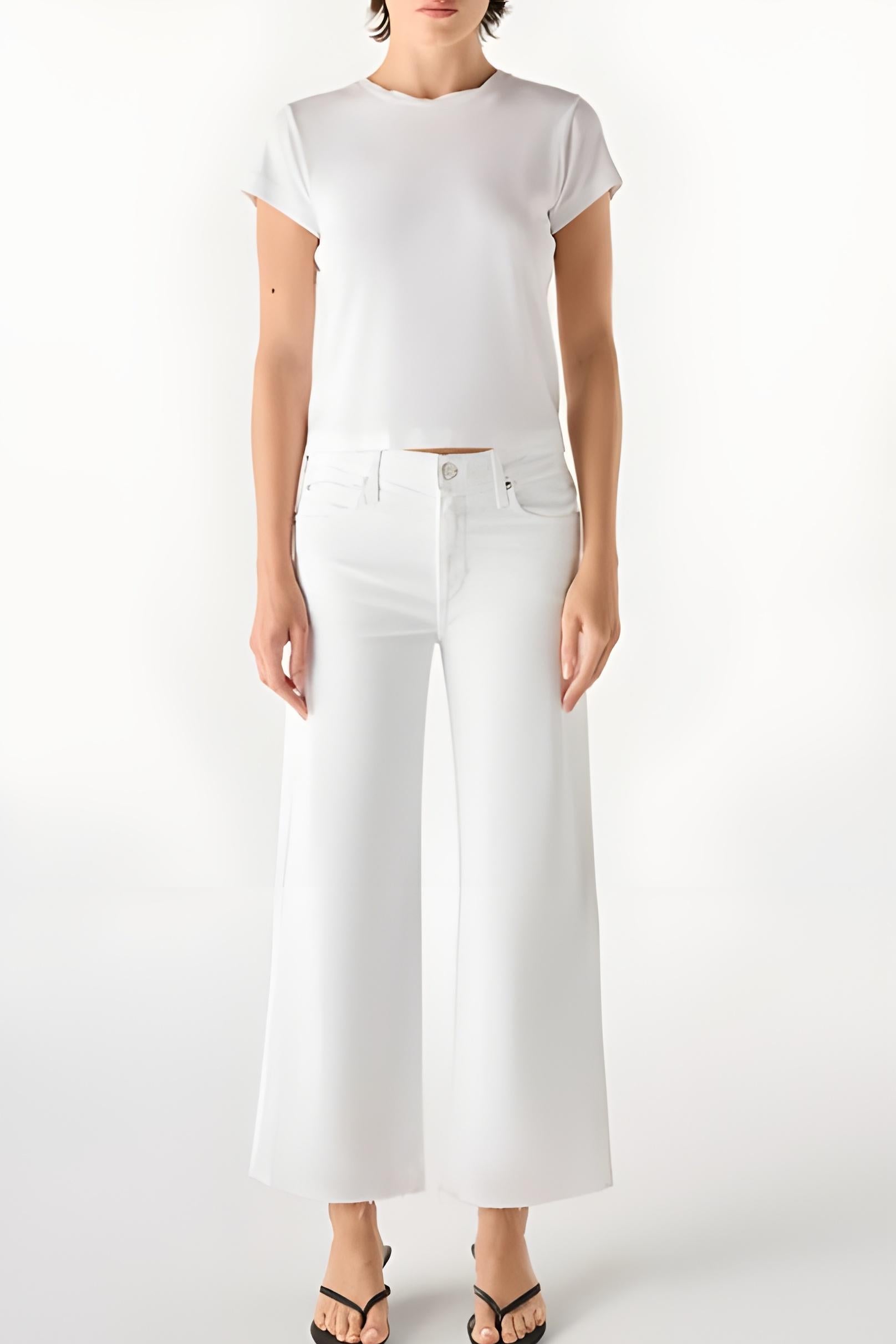 Person wearing a white t-shirt and white wide-leg jeans on a white background