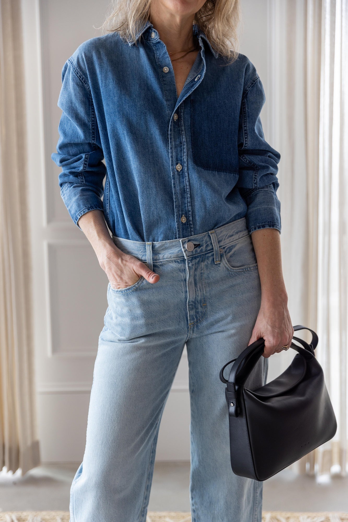 image of woman wearing the Amo Ruth denim shirt and billie jeans with the Aesther Ekme Baguette Bag