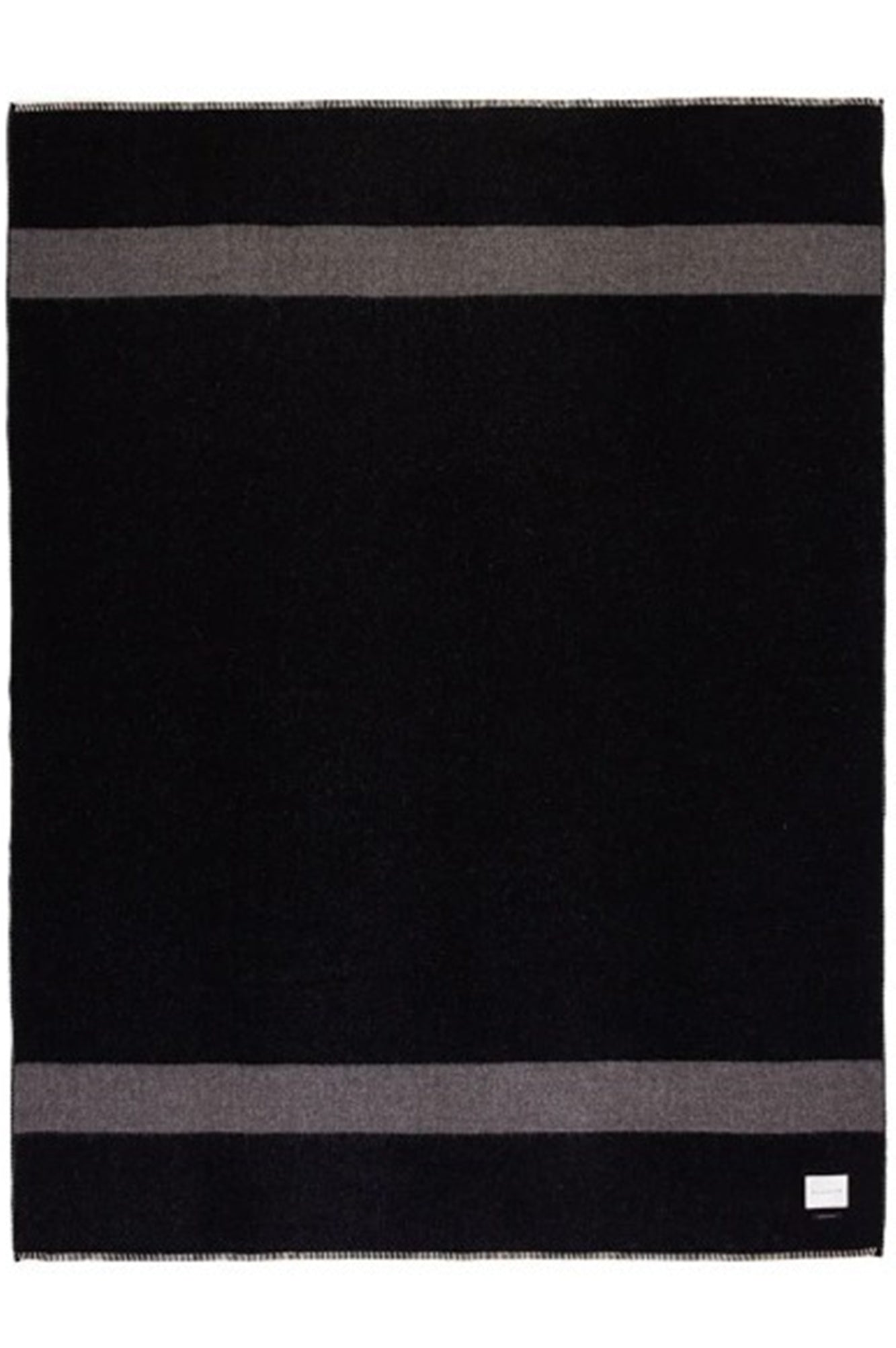 Black and gray striped rug with a brand logo in the corner