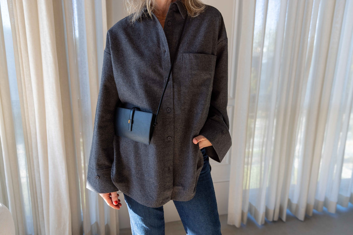 by Malene Birger Derris Flannel Shirt in dark grey melange with the black Vera Phone Case worn crossbody, styled with jeans